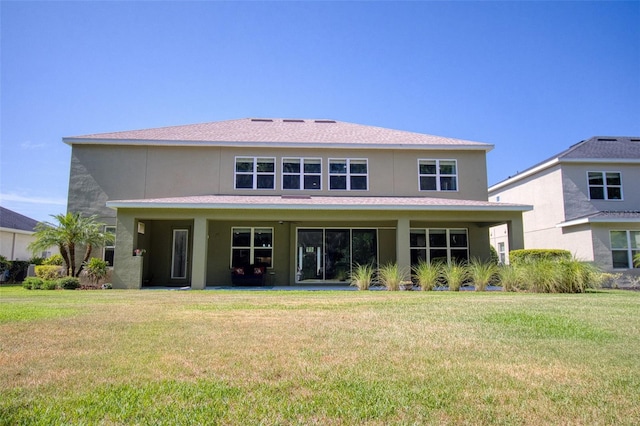 rear view of property with a lawn