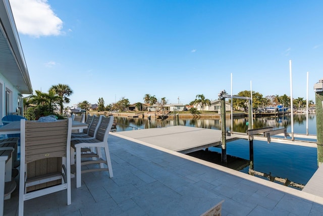 view of patio with a water view and a boat dock