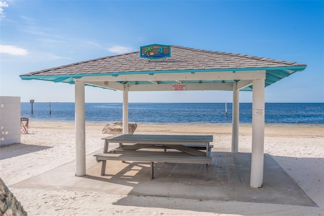 view of community featuring a gazebo, a water view, and a view of the beach