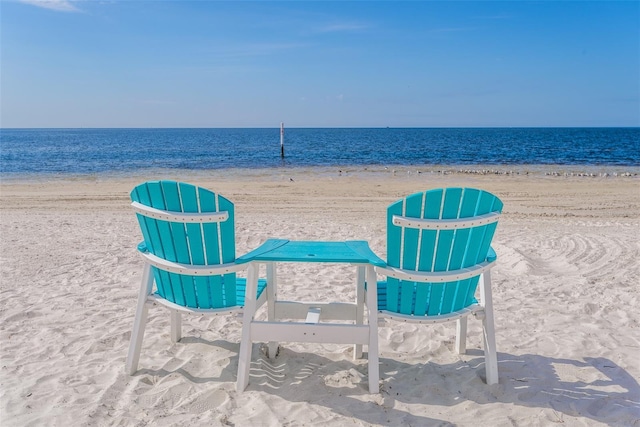 view of property's community featuring a beach view and a water view