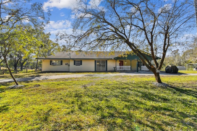 ranch-style house with a porch and a front yard