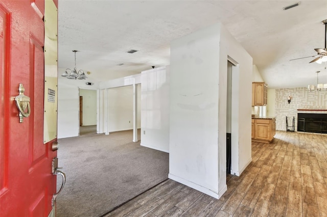 interior space featuring a notable chandelier, dark hardwood / wood-style floors, and lofted ceiling