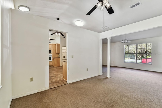 unfurnished room with carpet floors, a chandelier, and lofted ceiling