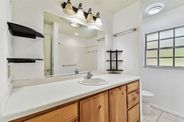 bathroom featuring tile patterned floors, vanity, and toilet