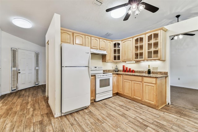 kitchen featuring white appliances, light brown cabinetry, and light hardwood / wood-style flooring