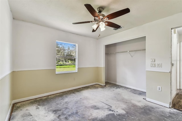 unfurnished bedroom featuring ceiling fan, a closet, and concrete flooring