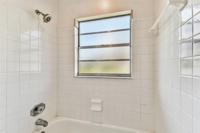 bathroom featuring tiled shower / bath combo and a wealth of natural light