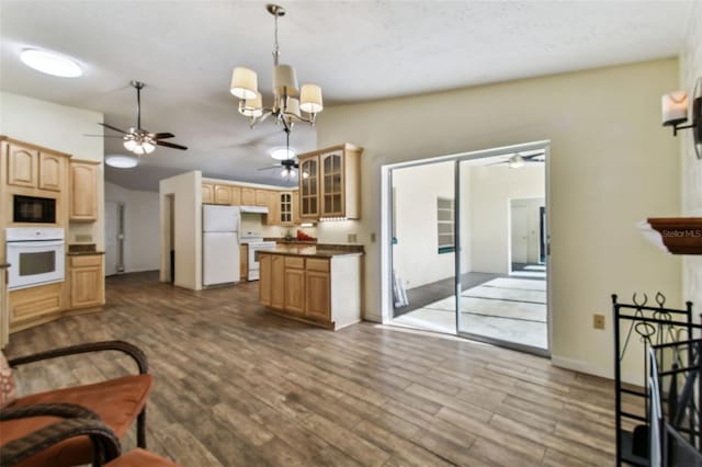 living room with hardwood / wood-style floors, lofted ceiling, and a notable chandelier