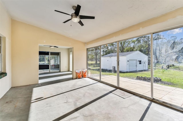 unfurnished sunroom with a wealth of natural light, ceiling fan, and vaulted ceiling