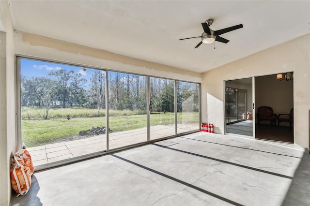 unfurnished sunroom with vaulted ceiling and ceiling fan