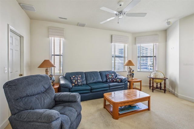 carpeted living room with ceiling fan