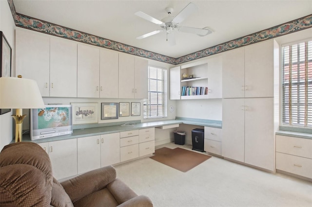 office area featuring ceiling fan and built in desk