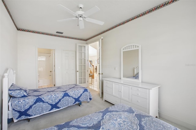 carpeted bedroom with ensuite bathroom, ceiling fan, and crown molding