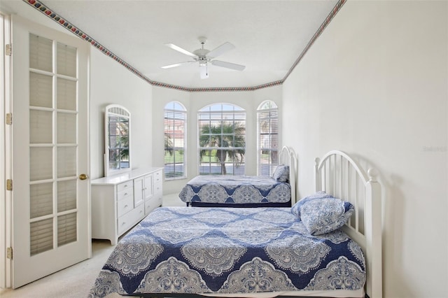 bedroom featuring ceiling fan, ornamental molding, and light carpet