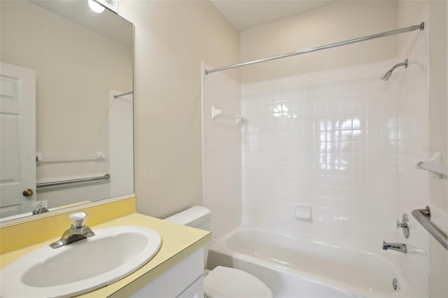 full bathroom featuring tiled shower / bath combo, toilet, and vanity