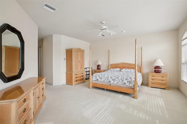 carpeted bedroom with ceiling fan and multiple windows