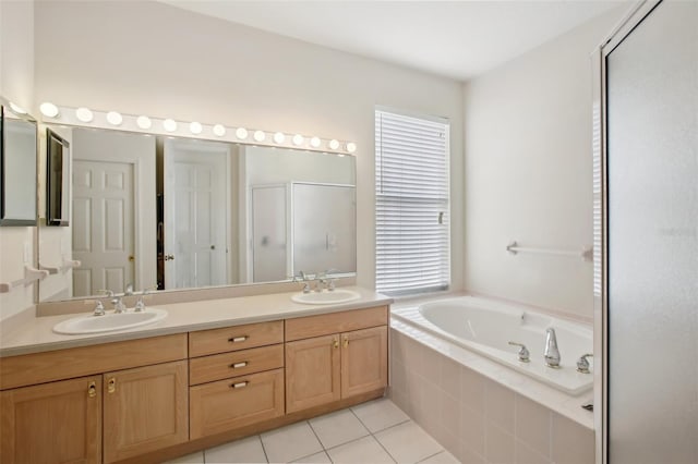 bathroom with tile patterned floors, vanity, and shower with separate bathtub