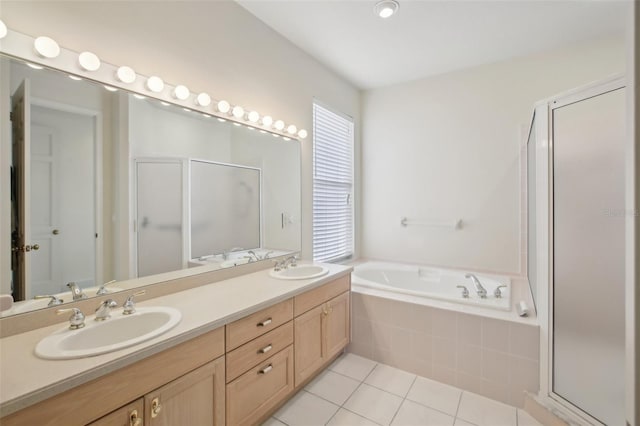 bathroom featuring tile patterned floors, vanity, and shower with separate bathtub