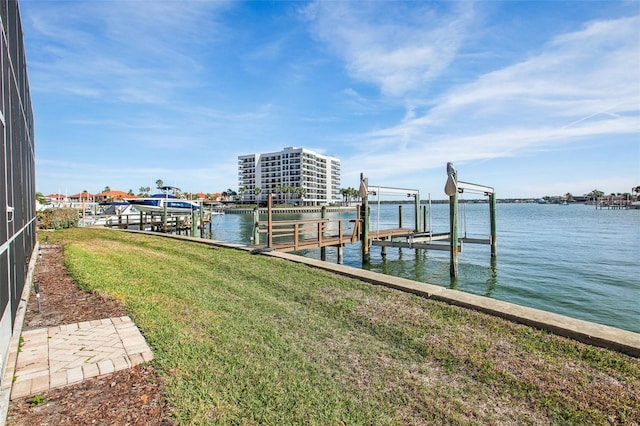 dock area featuring a water view and a lawn