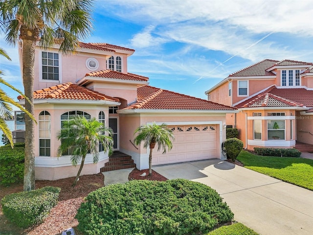 mediterranean / spanish-style home featuring a garage