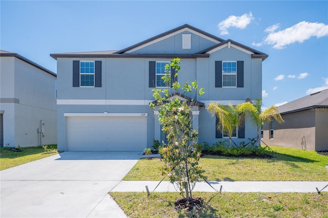 view of property with a garage and a front lawn