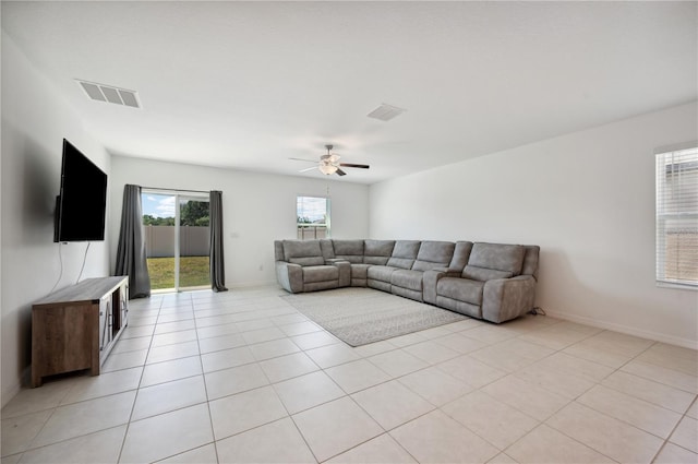 living room with light tile patterned floors and ceiling fan