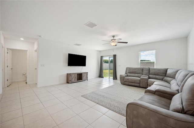 tiled living room with ceiling fan