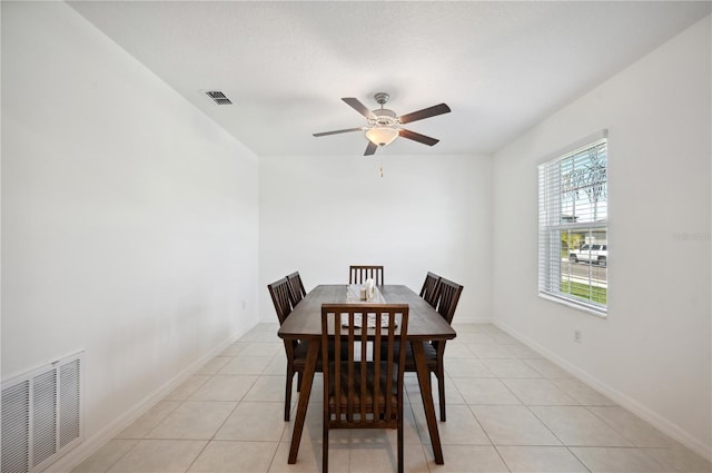 dining space featuring ceiling fan and light tile patterned floors