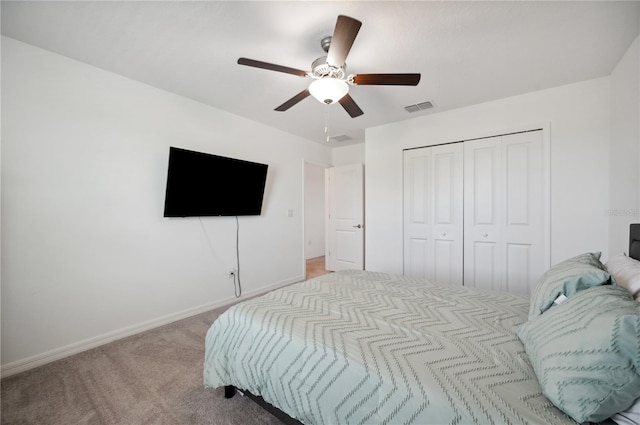 carpeted bedroom with ceiling fan and a closet