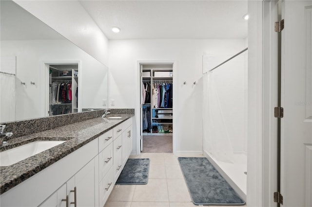 bathroom featuring tile patterned floors, a shower with curtain, and vanity