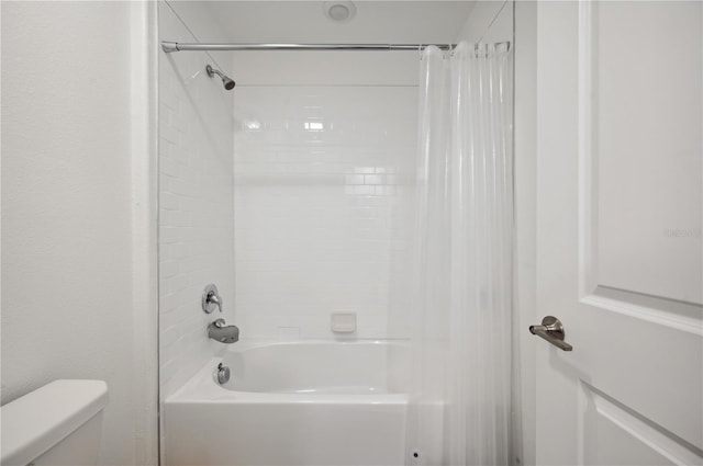 bathroom with shower / tub combo and toilet