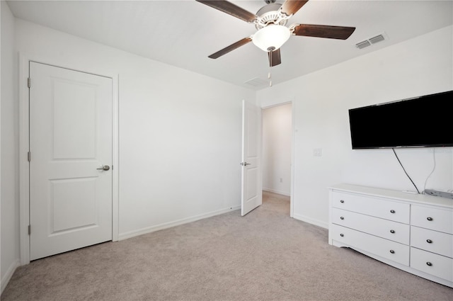 unfurnished bedroom featuring ceiling fan and light colored carpet