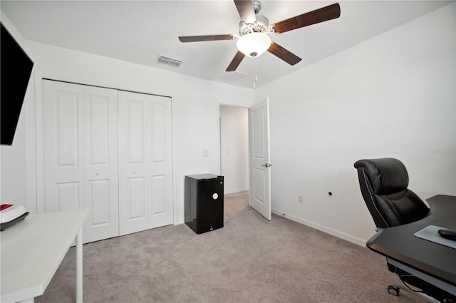 office space featuring light colored carpet and ceiling fan