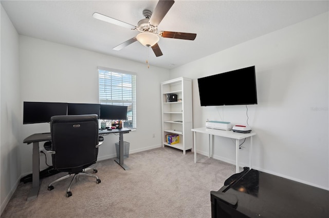 carpeted office featuring ceiling fan