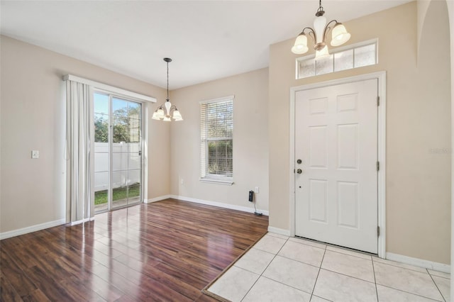 foyer featuring light hardwood / wood-style flooring and a notable chandelier