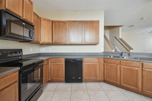 kitchen with sink, light tile patterned floors, and black appliances