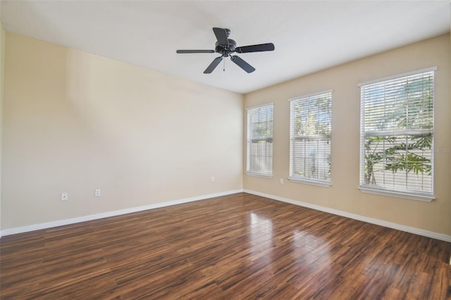 spare room with ceiling fan and dark hardwood / wood-style flooring