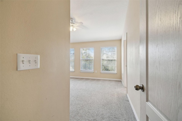 hall with light colored carpet