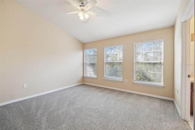 unfurnished room with ceiling fan, lofted ceiling, and carpet flooring