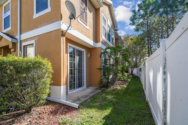 view of property exterior featuring a lawn