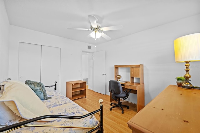 bedroom featuring visible vents, a closet, light wood-style flooring, and a ceiling fan