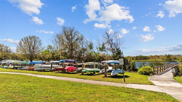 view of property's community featuring a yard and a water view