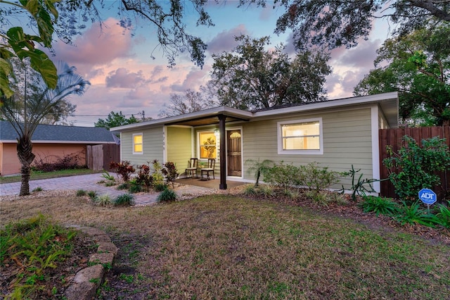 ranch-style home with a yard