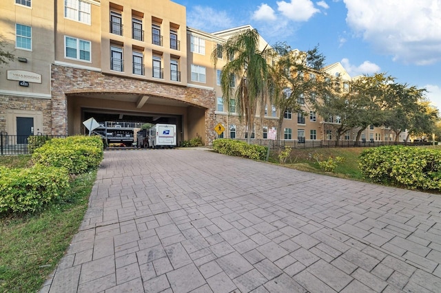 view of property's community with decorative driveway