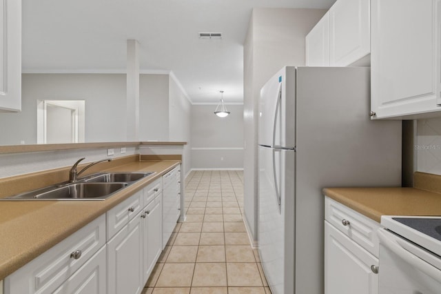 kitchen featuring white appliances, a sink, visible vents, white cabinets, and decorative light fixtures