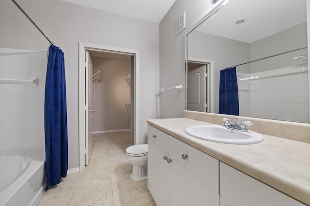 bathroom with shower / bath combo, toilet, tile patterned floors, a walk in closet, and vanity