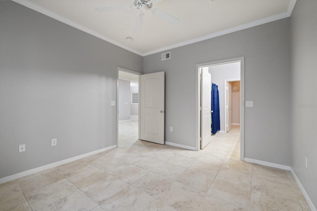 unfurnished bedroom with a ceiling fan, baseboards, visible vents, a spacious closet, and crown molding