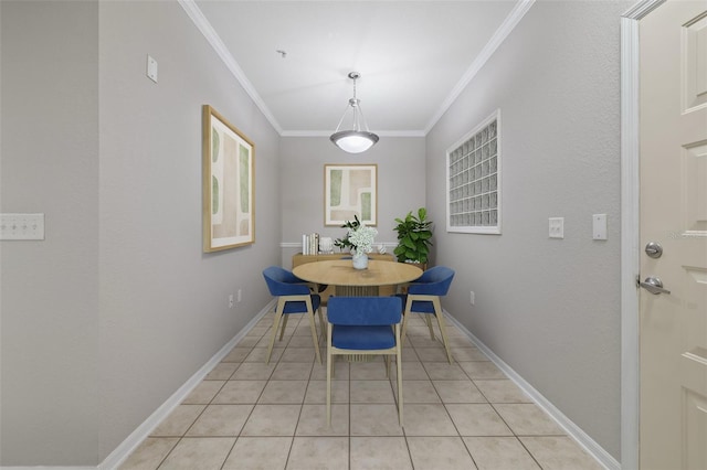 dining room with light tile patterned floors, ornamental molding, and baseboards