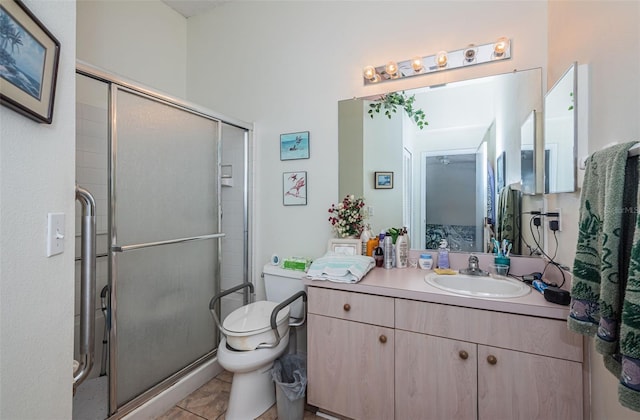 bathroom with tile patterned flooring, vanity, toilet, and a shower with shower door