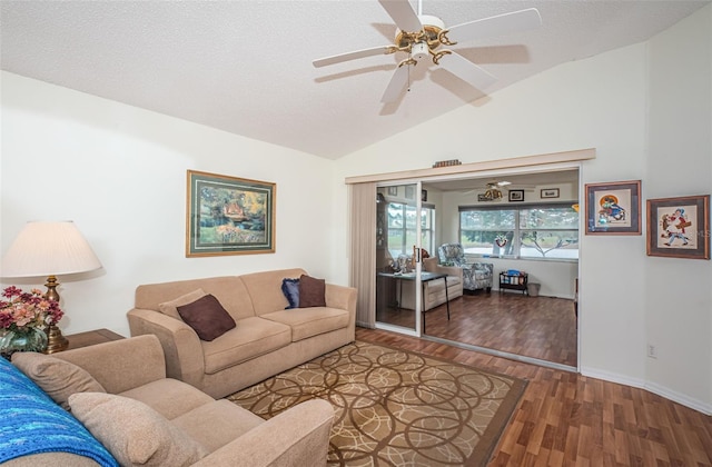 living room with hardwood / wood-style floors, a textured ceiling, ceiling fan, and lofted ceiling